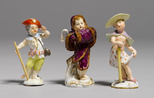 3 SMALL FIGURES OF CUPID,Meissen and another manufactory, ca. 1900 and later. Each of the three figures is dressed up, one as an Allegory of Winter, wearing a purple cape and a fur-lined muff, one as a gentleman hiking with a walking stick and a red hat, one as a gardener wearing a yellow hat and holding a hoe. 2 figures with underglaze blue sword marks, Model Nos. 6., 21. and 13. H 9 cm, 10 cm. Small chips. (3)