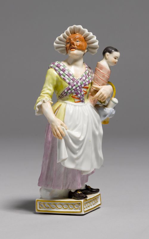 COMEDY FIGURE WITH AN INFANT,Meissen, from a series of Commedia dell'Arte figures, modern. Wearing a light-brown mask and a white flouncy bonnet, holding an infant and a basket in the crook of her left arm. Underglaze blue sword mark, model number 64563 impressed and press number 259 and symbol for the year. H 18.5 cm.
