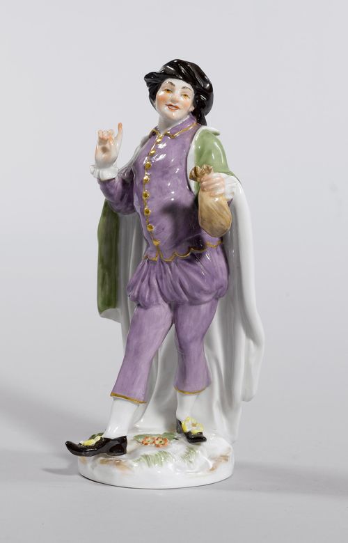 FIGURE OF "MEZZETIN",Meissen, from a series of Commedia dell'Arte figures, moulding 20th century. Wearing a black cap and holding a money pouch in his right hand. Wearing a green coat over a purple suit. Underglaze blue sword mark, model number 943. incised. Press number. H 16.5 cm.