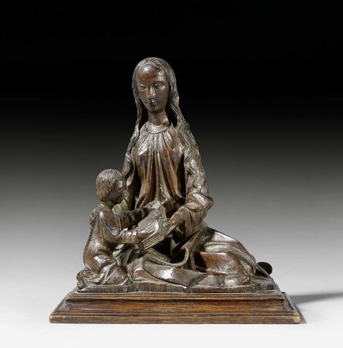 SAINT ANNE TEACHES MARY TO READ, in the Gothic style. Oak, carved full round and darkly stained. H 29 cm.