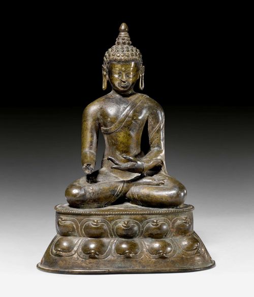 A SILVER-INLAID BRONZE FIGURE OF BUDDHA SHAKYAMUNI. West Tibet, 14th c., height 17.3 cm. Right hand and closure plate lost. Some damage.