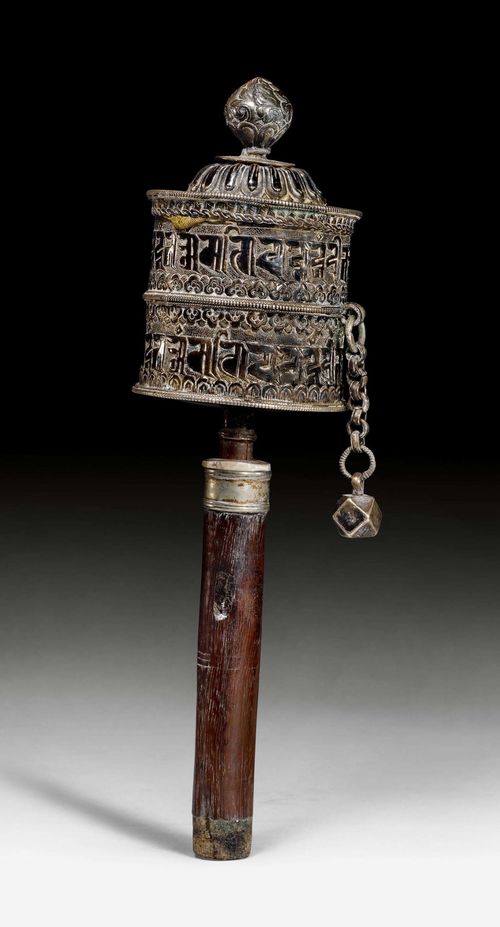 A SILVER PRAYER WHEEL. Tibet, ca. 19th c., length 25 cm. Wooden shaft.
