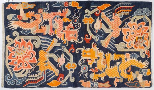 A WOOL SADDLE RUG WITH DRAGONS AND A PHOENIX ON A BLUE GROUND. Tibet, antique, 173x92 cm.