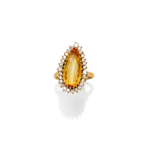 TOPAZ AND DIAMOND RING. Yellow gold 585. Gold ring, set with 1 orange, pear-shaped topaz weighing ca. 5.00 ct, within a border of 26 brilliant-cut diamonds weighing ca. 0.40 ct. Size ca. 53, with size adjustment insert.