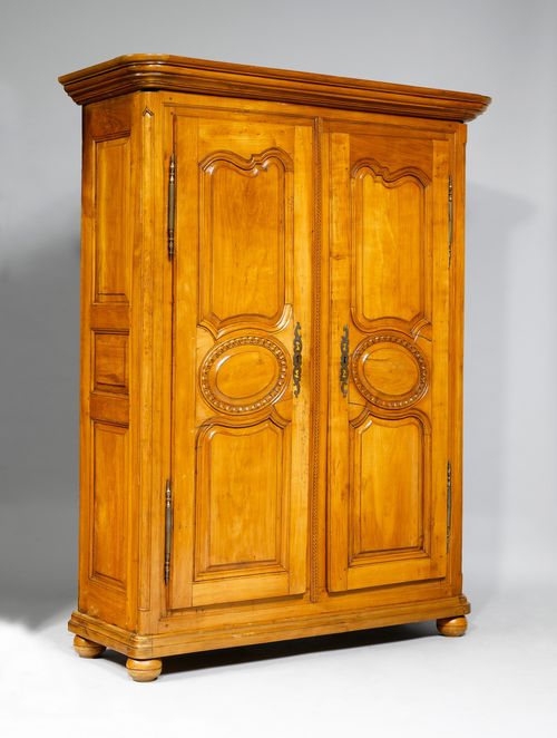 CUPBOARD,probably from the region around Gruyères, 18th century. Moulded cherry, carved with leaf friezes. Rectangular body. Front with 2 doors. Iron mounts. 150x53x197 cm. 1 key. 1 lock, later.