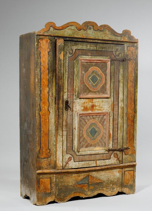 PAINTED CUPBOARD,from the Alpine region, probably Bavaria or the Inn Valley, 19th century, inscribed HANS GEORG NEFF. Pinewood, painted with geometric reserves, fillets, pine cones and pillars on a brown/green/grey ground. Rectangular body. Front with double-panelled door. Iron mounts. 120x46x187 cm. Door warped. Some losses. 1 key.