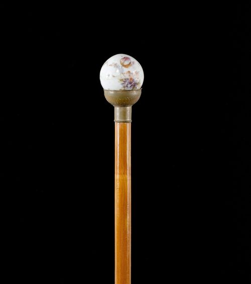 WALKING STICK WITH SPHERICAL TIP,French, 19th century. White porcelain sphere, decorated with flowers, mounted in brass. Bamboo stick with metal tip. L 95.3 cm.