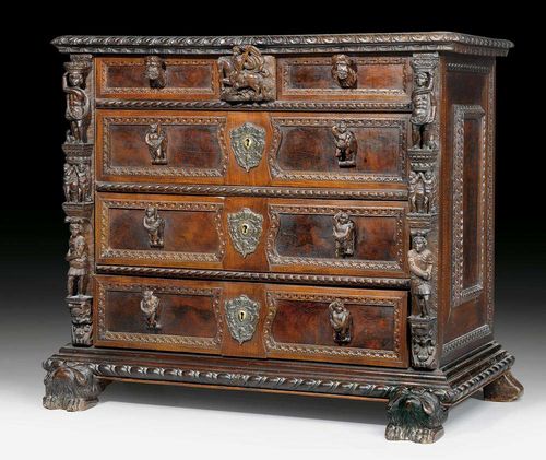 WALNUT CHEST OF DRAWERS "A BAMBOCCI", Renaissance style, Genoa, 19th century. Richly carved with "bambocci", masks, leaves and frieze. With overhanging top, shaped plinth on paw feet and 4 drawers at the front, the top one being divided into three. 117x60x101 cm. A very similar chest of drawers is illustrated in: M. Cera, Il mobile italiano, Milan 1983; p. 50 (ill.59).