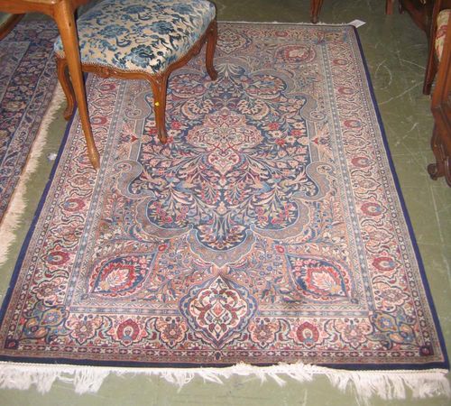 GHOM.Beige and blue central field with a white central medallion, finely patterned with flowers and birds, light edging, good condition, 210x125 cm.