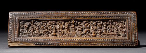 A WOODEN BOOK COVER CARVED WITH A BUDDHA TRIAD ON A CLOUD GROUND. Tibet, ca. 16th c. 36.4x10.4x2 cm. Carving has minor chips. Minor damage on edge.