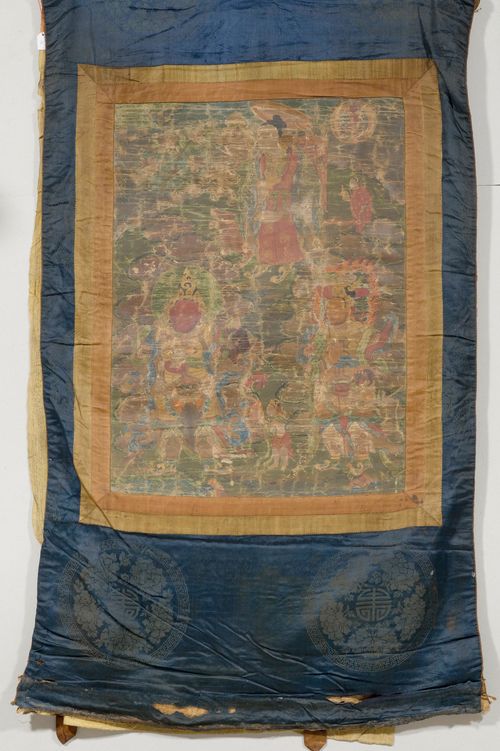 A THANGKA OF DHARMATALA WITH TWO QUEENS OF HEAVEN. Tibet, 18th c. 63x45 cm. Fine painting, severely damaged. Brocade mounting.