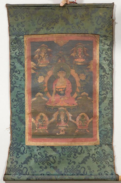 A THANGKA OF SHAKYAMUNI WITH WHITE TARA, AMITAYUS, AND VAJRADHARA FLANKED BY AMOGASIDDHI AND VISVAPANI. Tibet, 19th c. 53x36 cm. Two painted borders. Green brocade mounting. Severly sooted and stained.