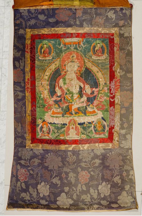A THANGKA OF VAJRADHARA WITH AMITABHA, SHAKYAMUNI, WHITE TARA AND MANJUSHRI. Tibet, 18th c. 57x42 cm. Brocade frame. Damage due to age.