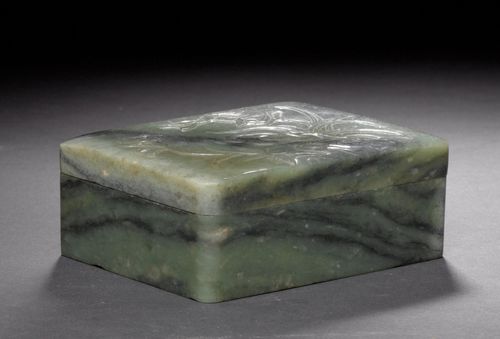 A GREEN JADE BOX AND COVER CARVED WITH A BIRD, FLOWER AND ROCK. China, late Qing Dynasty, 11.5x9.2x4.6 cm. Minor edge chips.