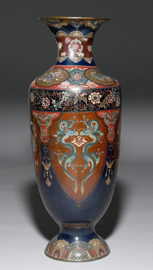 BLUE GROUND CLOISONNÉ BALUSTER FLOOR VASE WITH DECORATION IN POLYCHROME COLOURS OF DRAGONS AND PHOENIXES IN CARTOUCHES WITH SHISHI MEDALLIONS AND AREAS OF BROCADE. Japan, Meiji Period, Height 121 cm. Balusterform. Damaged, restored.