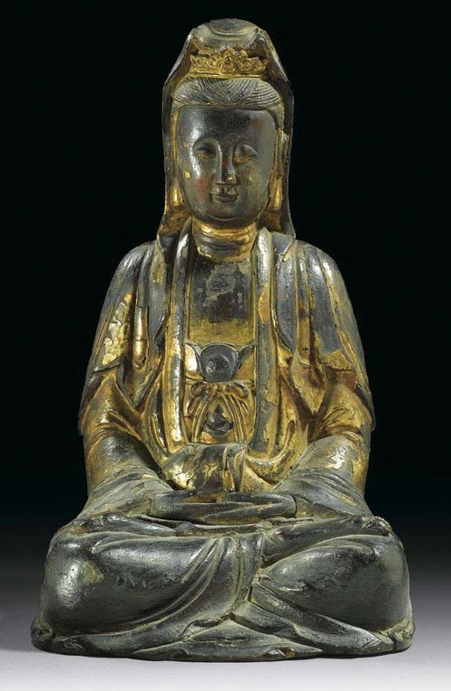 GUANYIN. Dark bronze with residue of a lacquer gilding. Finely-worked face with downcast eyes.China, Ming Dynasty, H 34.5 cm.