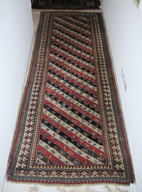 GENDJE old. Diagonal patterned central field in red, blue and white.  Good condition. 285x100 cm.