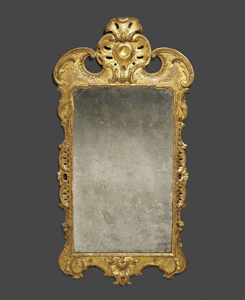 MIRROR, George I, England circa 1720. Pierced and finely carved wood and stucco, with remains of old gilding. H 155 cm, W 74 cm. Provenance: - Christie's London on 7.7.1994 (Lot No 158). - Private collection, Geneva.