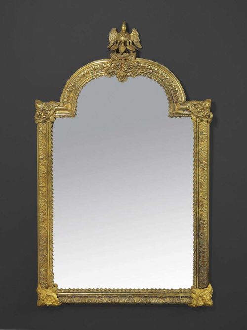 LARGE MIRROR "A L'AIGLE", late George III, probably England, 19th century Gilt bronze and brass, relief decorated with eagles, putti, leaves and cartouches.  Restored.  H 103 cm, W 58 cm. Provenance: Private collection, Belgium.