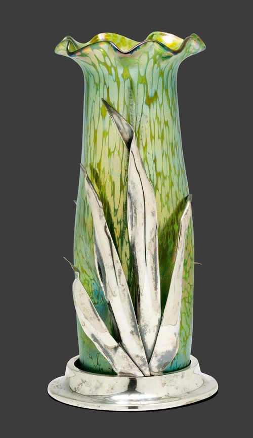 Attributed to LOETZ, VASE, circa 1900 Green iridescent glass with silver-plated metal mount. In the shape of a flower with foliate decoration. H. 26 cm.