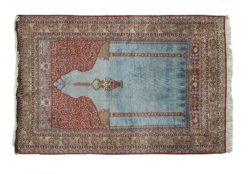 KESHAN SILK PRAYER RUG, old. Light blue Mihrab with red spandrels, green border finely decorated with floral pattern. Good condition.210x135 cm.