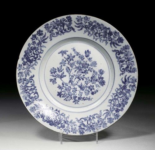 DISH ' A STAMPINO', Doccia, circa 1740-45. With blue stamped decoration of flowers and Laub und Bandelwerk, edged in brown, 37cm.