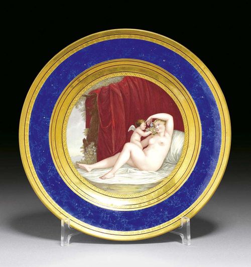 PLATE'VENUS', Berlin, KPM, circa 1803-13. Antiqueglatt, painted with the scantily clad Goddess and Cupid, titled to the back on a lapis blue ground around the rim in gilt borders, sceptre mark in underglaze-blue and painter's mark in blue, painter's numeral 20. in iron-red, impressed mark, 24,5cm. Provenance: Private collection, South Germany.
