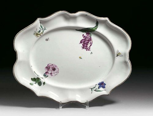 OVAL DISH, Strasbourg, Paul Hannong, circa 1754-60. Façon d'argent, painted with 'fleurs fines', a rose and a tulip and smaller flowers to the rim, edged in brown, painter's mark P in manganese. 45cm. Haircrack of 7 cm length. Provenance: Private collection, Basel.