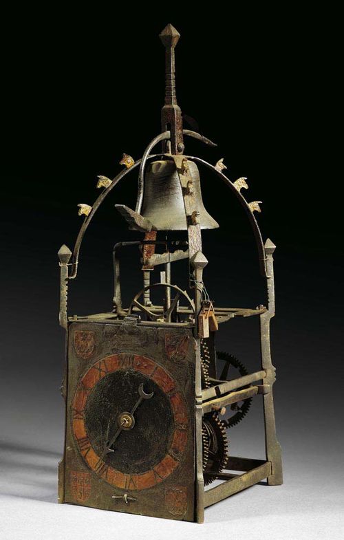 PAINTED HOUSE CLOCK, Renaissance, France circa 1500. The chapter ring with 4 coats of arms, with striking mechanism and count wheel. Paintwork retouched. With later ebonised bracket. 17x18x48 cm. Provenance: - Honegger collection, Zurich. -  Galerie Koller auction, Zurich on 23.6.2005 (lot 1016). - German collection. Very good condition.