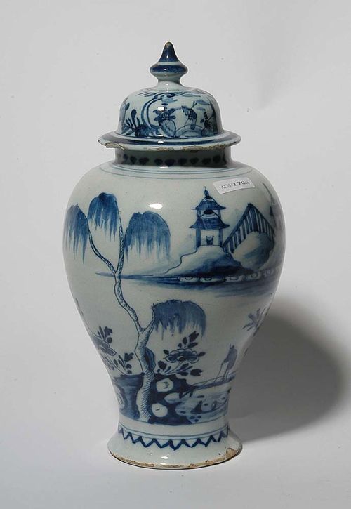 DELFT VASE AND COVER, circa 1700. Painted in blue with Chinese garden landscape with figures. The lid probably not matching. H 31cm. Some flaking to the glaze on both rims, the lid with small repairs to the rim. Provenance. private collection, South Germany.