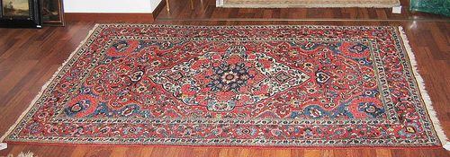 BACHTIAR antique. Red central field with white central medallion lavishly decorated with flowers. Red border. Good condition. 136x213 cm.