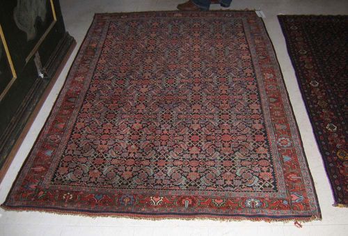 FERAHAN old. Dark central field with stylised flowers in pink and green tones. Red border. Good condition. 220x140 cm.