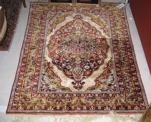 SILK KAISERY, old. Red central medallion on light ground with yellow corner motifs. With stylised trailing flowers and red/yellow border. 170x130 cm.