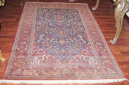 KESHAN old. Blue ground finely patterned with trailing flowers. Red border. Good condition. 211x138 cm.