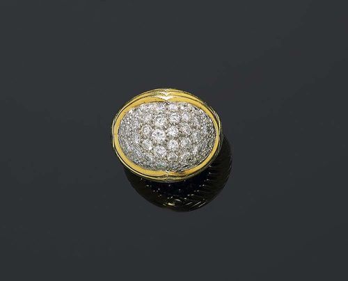 GOLD AND BRILLIANT-CUT DIAMOND RING. Yellow and white gold 750. Attractive, solid ring with a ribbed surface. The convex top is set with 45 pavé-set brilliant-cut diamonds totalling ca. 3.40 ct. Size ca. 52. Matches the previous lot.