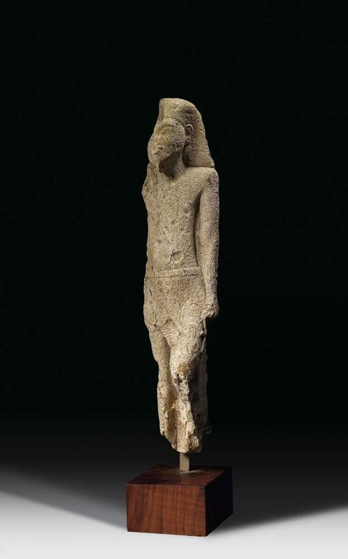 FIGURE OF A PRIEST, Egypt circa 800/500 BC Weathered chalk. Verso with hyrogliphic inscription. Mounted on wooden plinth. H 32 cm.
