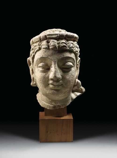 BODHISATTVA, Gandhara, ca. 4./5 century AD Painted stucco, in three-quarter relief, partly covered in earth. Mounted on wooden plinth. H 16.7 cm.