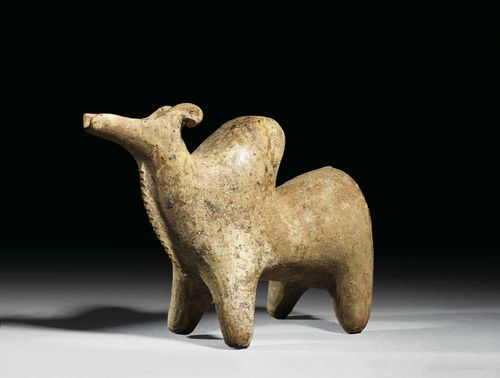 VESSEL FOR POURING, Iran, in the style of the 8/7 century BC Burnt clay in the form of a bull. The spout restored. 18.3x23.4 cm.