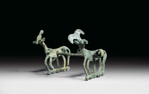 DECORATED HORSE BIT, probably Luristan, 8./7. century BC. Bronze. The sides decorated with ibex. Green-brown Patina. 11x12.5 cm.