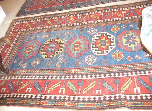 KAZAK gross, old. Dark blue central field with five octagonal medallions, broad, red wine glass border, considerable wear,  225x150 cm.