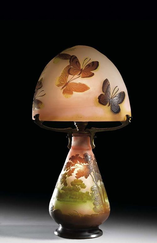 LAMP, Gallé. White and pink glass with double overlay in green and brown, the foot etched with river landscape, the shade with butterflies, both parts signed Gallé, H. 40 cm.