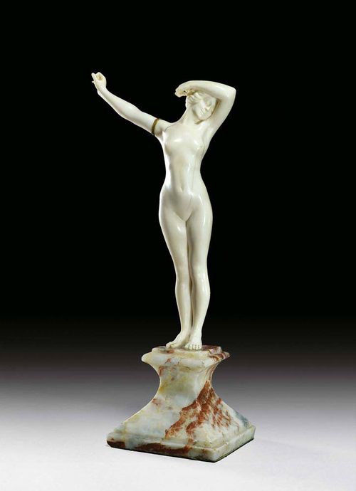IVORY SCULPTURE OF A FEMALE NUDE, ca. 1920. On marble plinth. H. 26 cm.