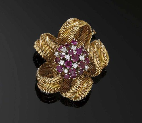 RUBY, DIAMOND AND GOLD BROOCH, LOTOS, ca. 1950. Yellow gold 750. Classic brooch in  a stylized floral form, the middle is set with 18 rubies totalling ca. 1.80 ct and 9 brilliant-cut diamonds totalling ca. 0.20 ct, the leaves are made of rolled-up gold bands, signed Lotos.