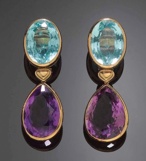 PAIR OF TOPAZ AND AMETHYST PENDANT EARRINGS. Yellow gold 750. Each clip set with 1 amethyst drop totalling ca. 42.00 ct, supported by a small gold heart and 1 oval topaz (treated) totalling ca. 36.00 ct. En suite to following lot.