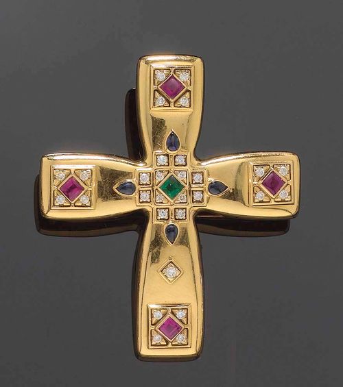 GOLD AND GEMSTONE BROOCH/PENDANT, CARTIER 1993. Yellow gold 750. Saint Petersbourg model, of cross design, the centre and the ends of the cross decorated with applied ornaments set with 4 small ruby carrés, 2 sapphire drops, 1 emerald carré and 28 brilliant-cut diamonds totalling ca. 0.35 ct. Signed, dated and numbered C47503 on the back of the clip pin.