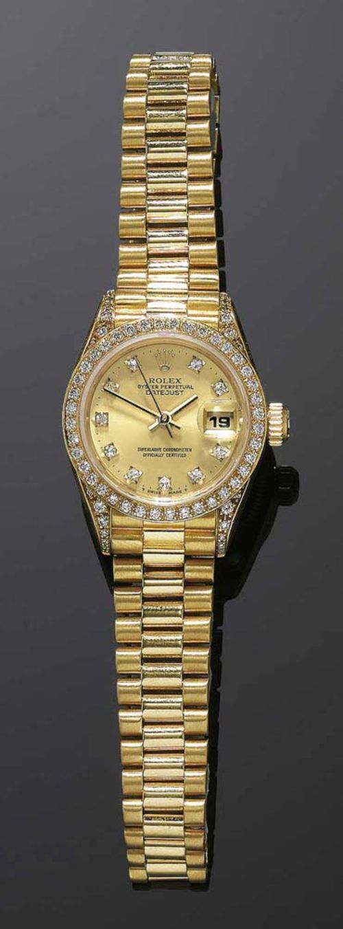 DIAMOND LADY'S WRISTWATCH, ROLEX DATEJUST ca. 2000. Yellow gold 750. Gold case No. 9721597, with diamond lunette and attaches. Gold-coloured dial with diamond indices and gold-coloured hands, date window at 3h. Screw-down crown. Ref. 69158, automatic, movement No. 0704159, cal. 2135. President gold band with fold-over fastener. With case and value report from Bucherer, September 2005.