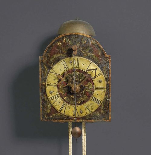 PAINTED IRON CLOCK WITH FRONT PENDULUM, Baroque, South German circa 1700. The sides painted with foliate cartouches, painted dial with brass chapter ring, verge escapement with iron and brass wheels and striking mechanism on bell. Paintwork re-touched. 14x14x21 cm. Provenance: O. Honegger collection  Zurich.