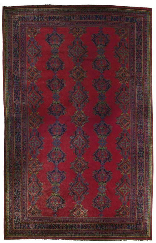 EUROPEAN SAVONNERIE, ca. 1930.Red background with five gul rows in green and blue, broad border with stylized plant motifs in blue, thick pile, in good condition, two small parts with signs of wear, 625x410 cm.