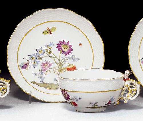 CUP AND SAUCER WITH 'BIENENMUSTER', Meissen, circa 1740.Rococo handle heightened in gold and shaped with a female head with green hat, basket weave border painted with bees and oriental flowers, gold edging. Underglaze blue sword mark, Impressed numbers 24 and 6. Provenance: from a private collection, Solothurn