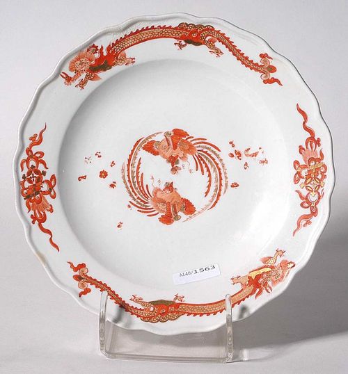 PLATE WITH RED DRAGON DECORATION, Meissen, circa 1740.Painted in iron red. The dragon with lucky symbols of eternal knot with pearls, coins, scroll and Artemisia leaf. Heightened in gold. Underglaze blue sword mark, impressed number 16. D 23.8 cm. Two small restorations on the edge, minor rubbing, star crack. Provenance: from a private collection, Solothurn